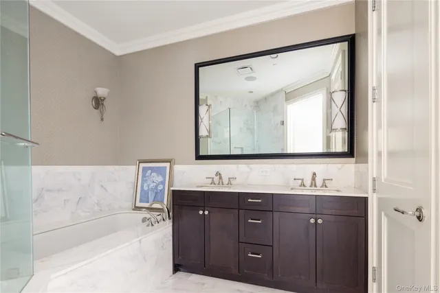 a bathroom with a bathtub sink vanity and mirror