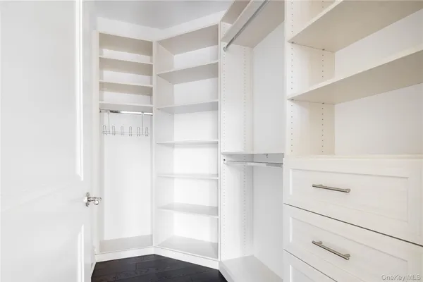 a view of walk in closet with empty racks