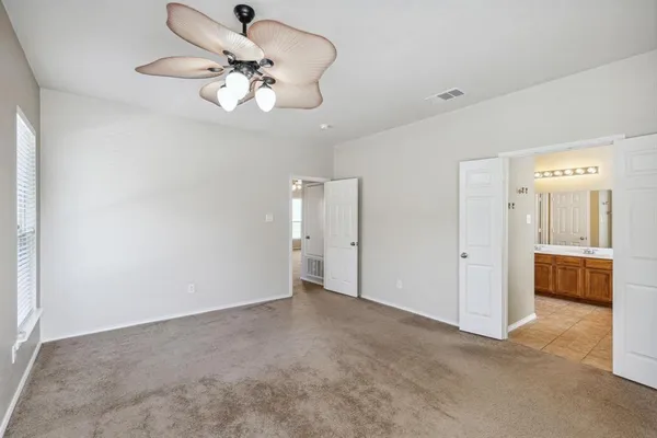 a bathroom with bathtub next to a window