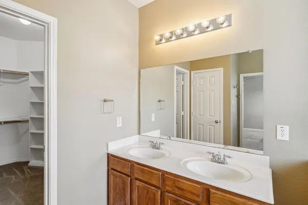 a view of walk in closet with empty racks