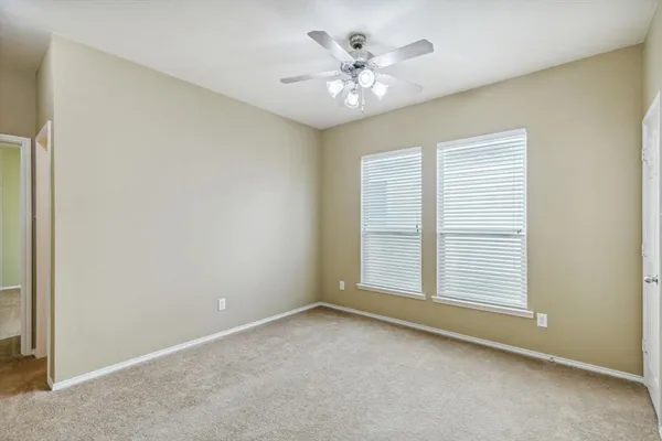 a view of a room with a chandelier fan