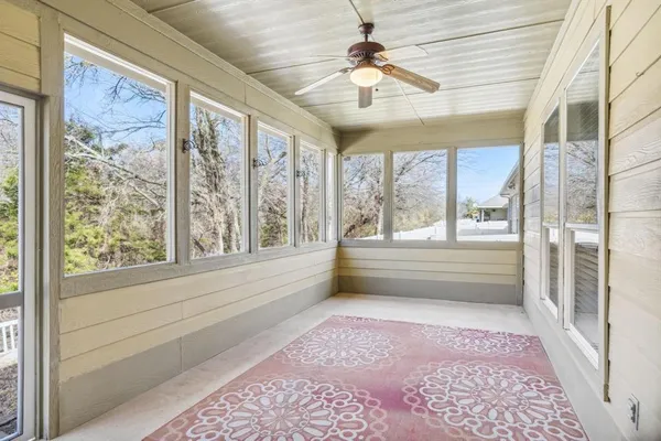 a view of hallway with a ceiling fan and a rug