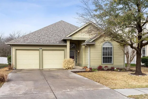 a view of a yard with wooden fence