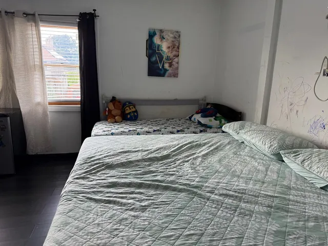 a living room with furniture and a bookshelf
