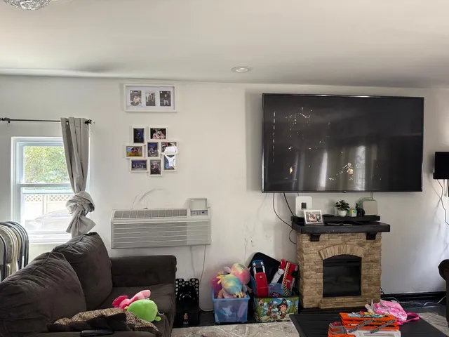 a living room with furniture a window and bookshelf