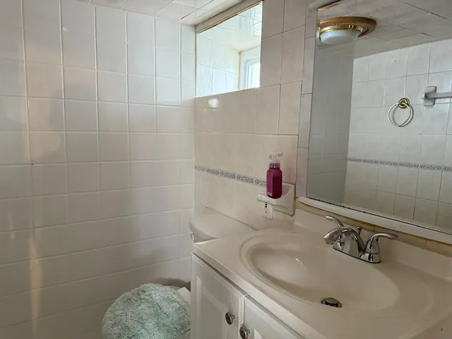 a view of a entryway door with clothes and shoes