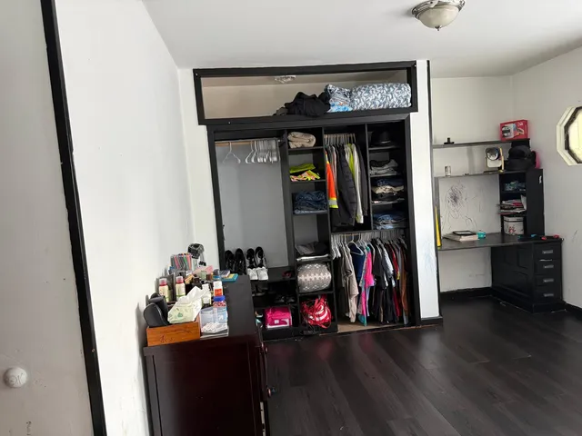 a view of a livingroom with furniture hardwood floor and a window