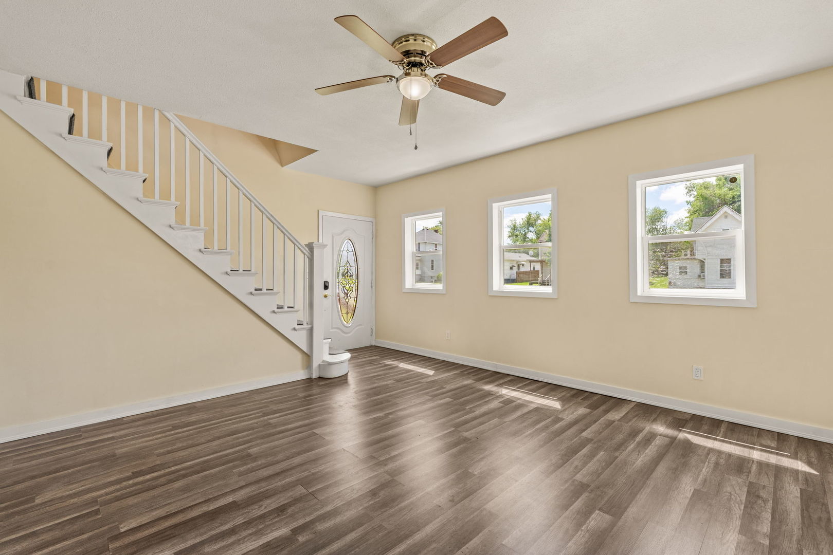 548 7th Avenue South Clinton, IA 52732 - Photo 3 of 23 a view of an empty room with wooden floor and a ceiling fan