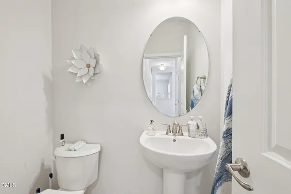 a bathroom with a sink mirror and toilet