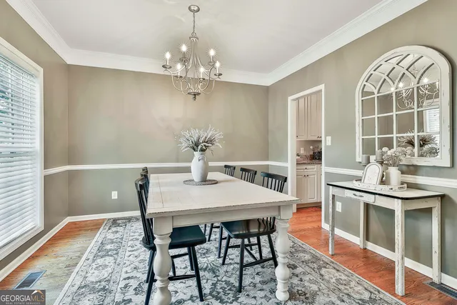 a view of a dining room with furniture window and wooden floor