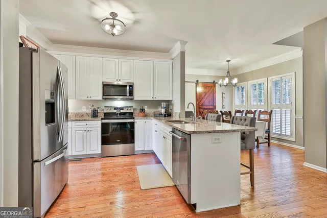a kitchen with stainless steel appliances granite countertop a refrigerator stove and microwave