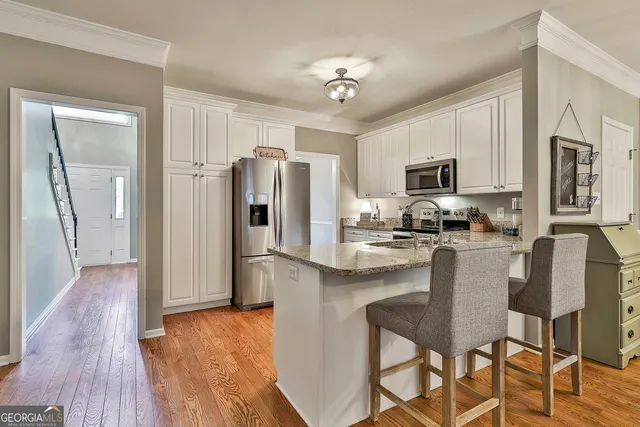 a view of a a dining room with furniture window and wooden floor