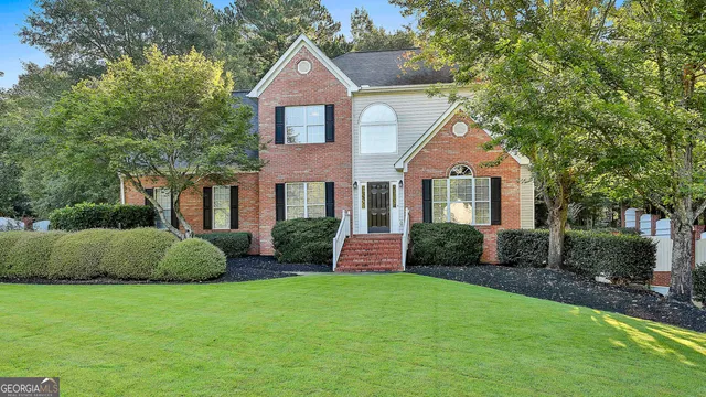 a front view of a house with a yard