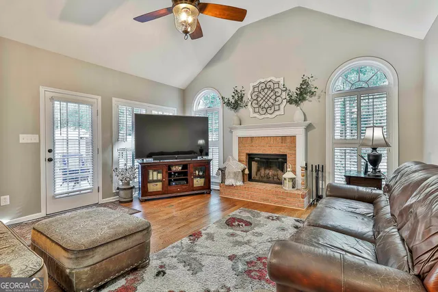 a spacious bedroom with a bed a mirror and a window