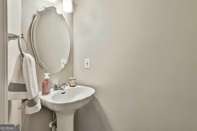 a white bath tub sitting next to a bathroom sink