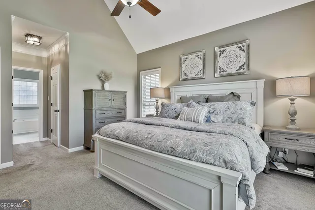 a view of staircase with lots of frames on wall and a chandelier