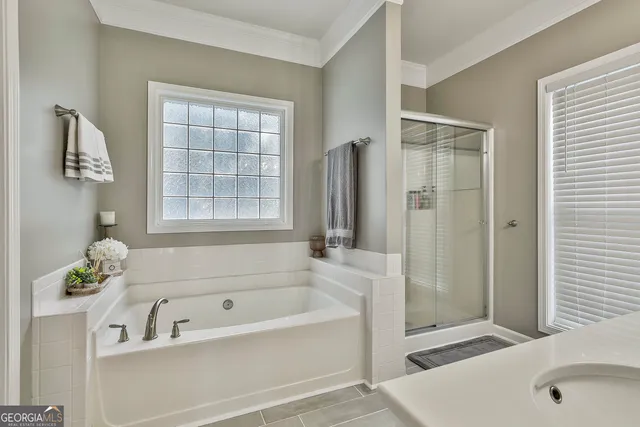 a bedroom with a bed a dresser and a flat screen tv