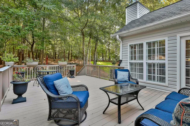 an aerial view of residential houses with outdoor space and trees all around