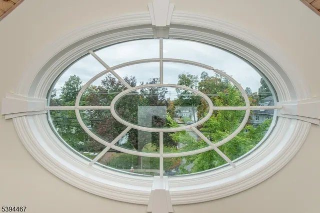 a view of a yard with a house and a large tree