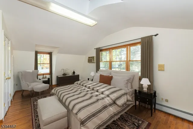 a bedroom with a bed and a large window