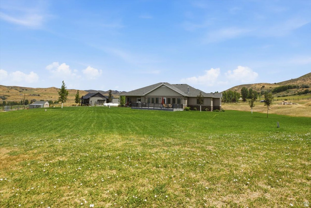 3123 East Riverdale Road Preston, ID 83263 - Photo 32 of 52 Expansive green lawn with a backdrop of rolling hills