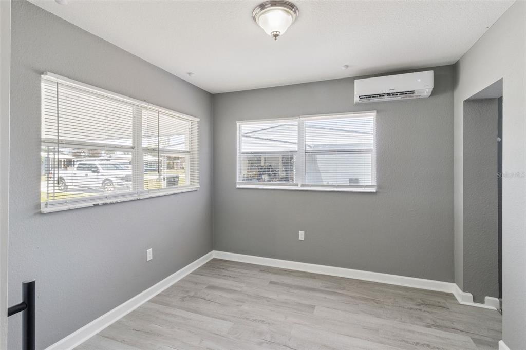 331 Walter Avenue Frostproof, FL 33843 - Photo 15 of 21 a view of an empty room with wooden floor and windows