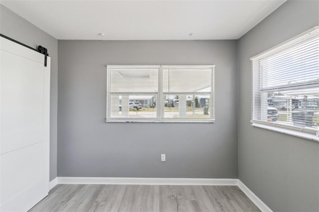 331 Walter Avenue Frostproof, FL 33843 - Photo 16 of 21 a view of an empty room with wooden floor and a window