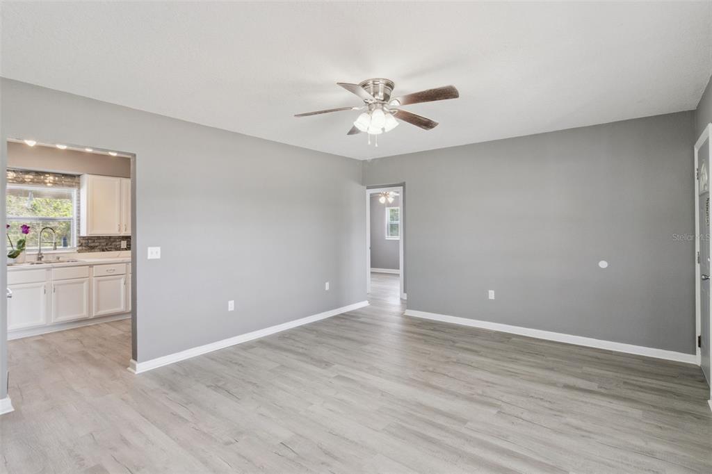 331 Walter Avenue Frostproof, FL 33843 - Photo 3 of 21 a view of an empty room with a window and wooden floor