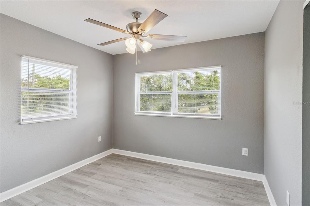 331 Walter Avenue Frostproof, FL 33843 - Photo 10 of 21 a view of an empty room with wooden floor and a window
