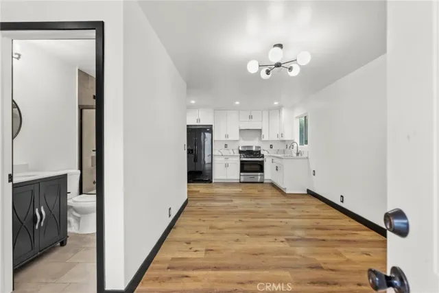 a view of kitchen with refrigerator and microwave