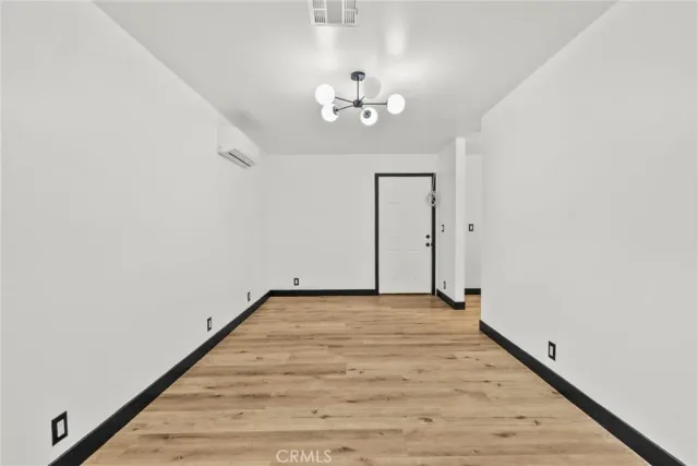 a view of an empty room with a chandelier
