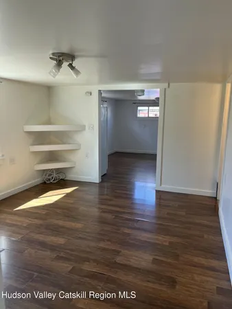 a view of a room with wooden floor