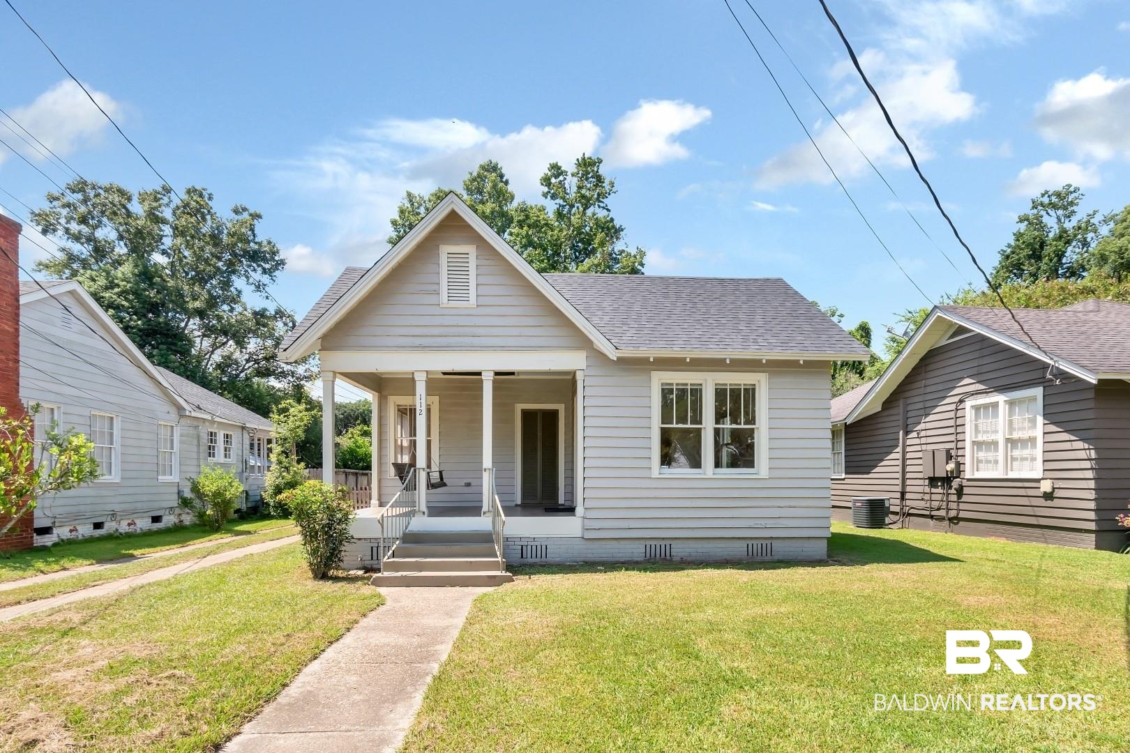 112 South Fulton Street Mobile, AL 36606 - Photo 2 of 35 Bungalow-style home with central AC, a front yard, and a porch