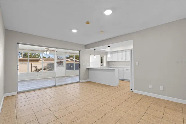 a view of a kitchen with furniture and an empty room
