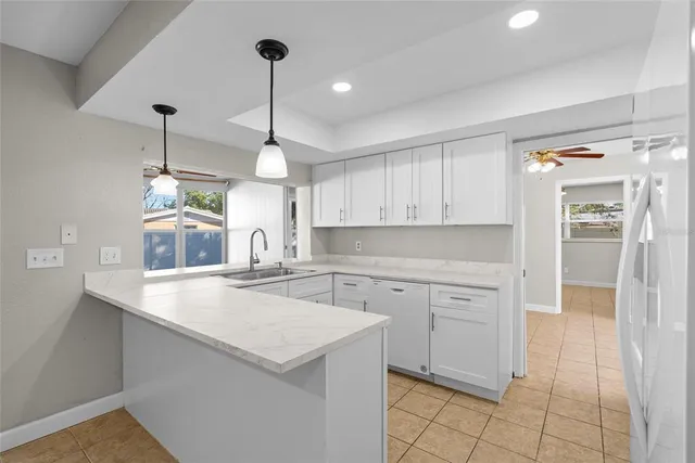 a kitchen with a sink a stove a microwave and cabinets