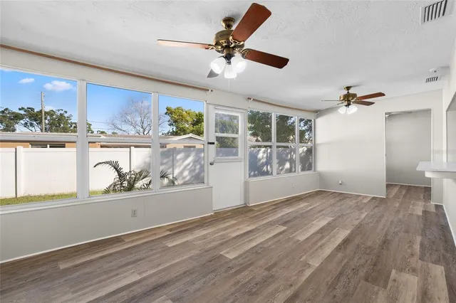 a view of work space with window and wooden floor