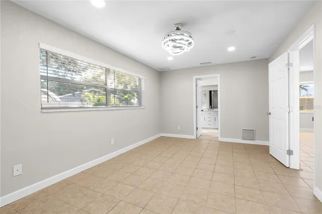 an empty room with windows and closet