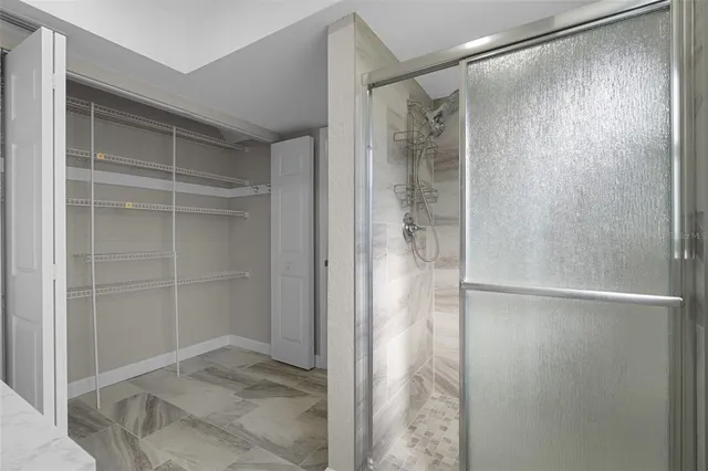 a bathroom with a glass shower door