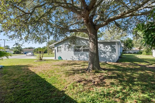 a view of outdoor space with garden and trees