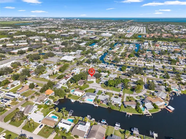 an aerial view of residential houses with city view