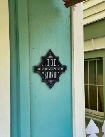 a view of a house with a small yard and wooden fence