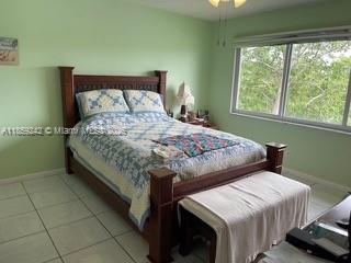 8981 South Hollybrook Boulevard, Unit 302 Pembroke Pines, FL 33025 - Photo 2 of 4 a bedroom with a bed and a window