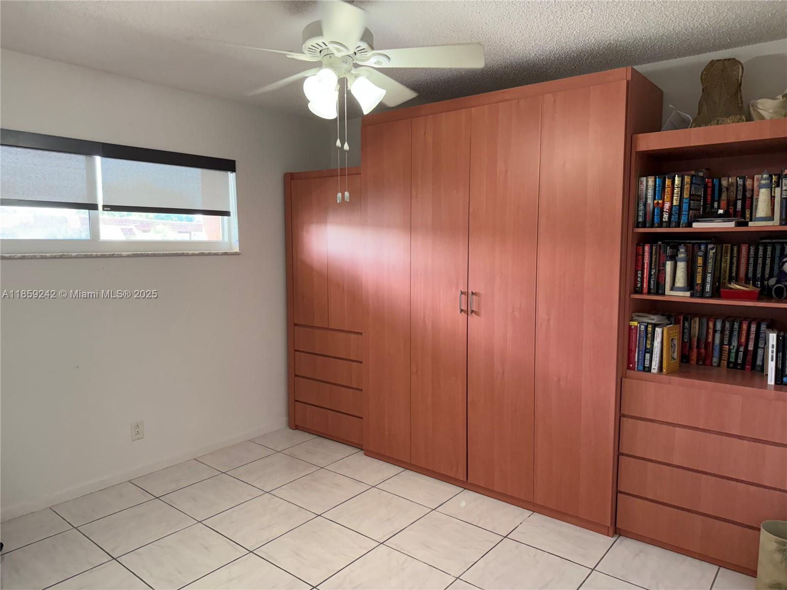 8981 South Hollybrook Boulevard, Unit 302 Pembroke Pines, FL 33025 - Photo 4 of 4 a view of a livingroom with a bookshelf