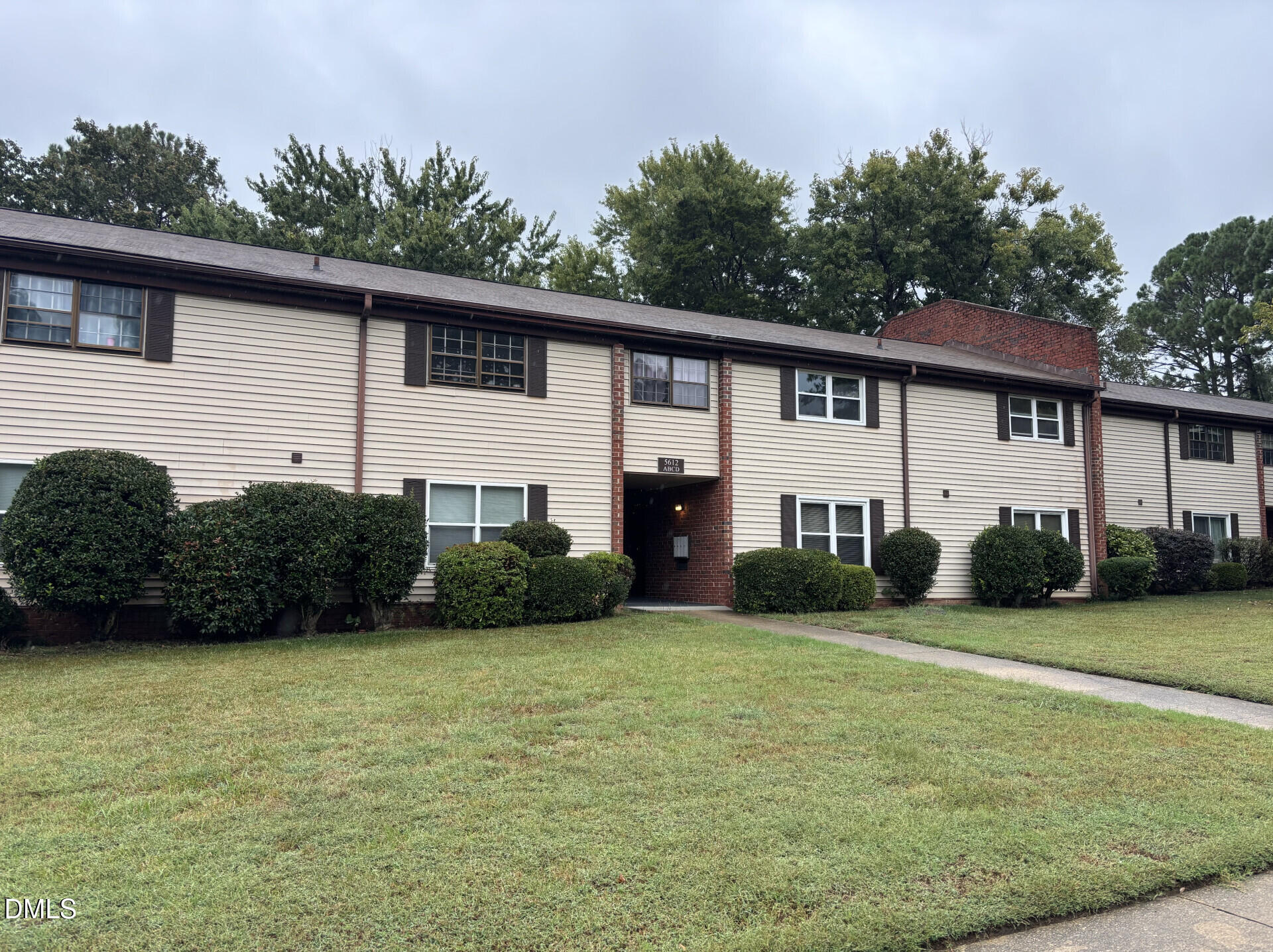 a view of a house with a yard and plants