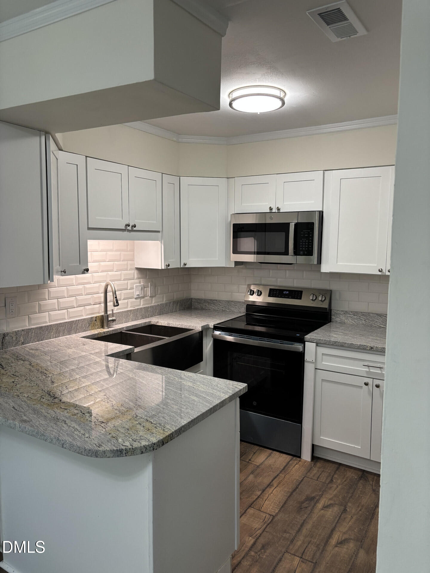 5612 Falls Of Neuse Road, Unit D Raleigh, NC 27609 - Photo 3 of 14 a kitchen with granite countertop a sink and steel appliances