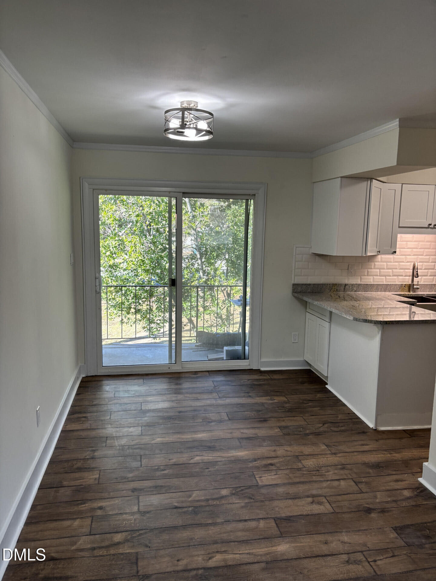 5612 Falls Of Neuse Road, Unit D Raleigh, NC 27609 - Photo 5 of 14 a view of kitchen with granite countertop cabinets and wooden floor