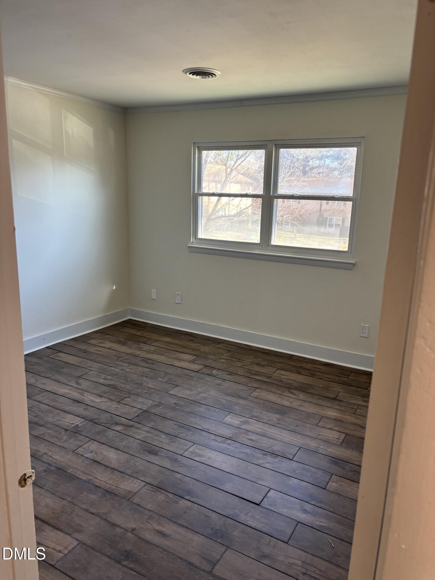 5612 Falls Of Neuse Road, Unit D Raleigh, NC 27609 - Photo 9 of 14 wooden floor in an empty room with a window