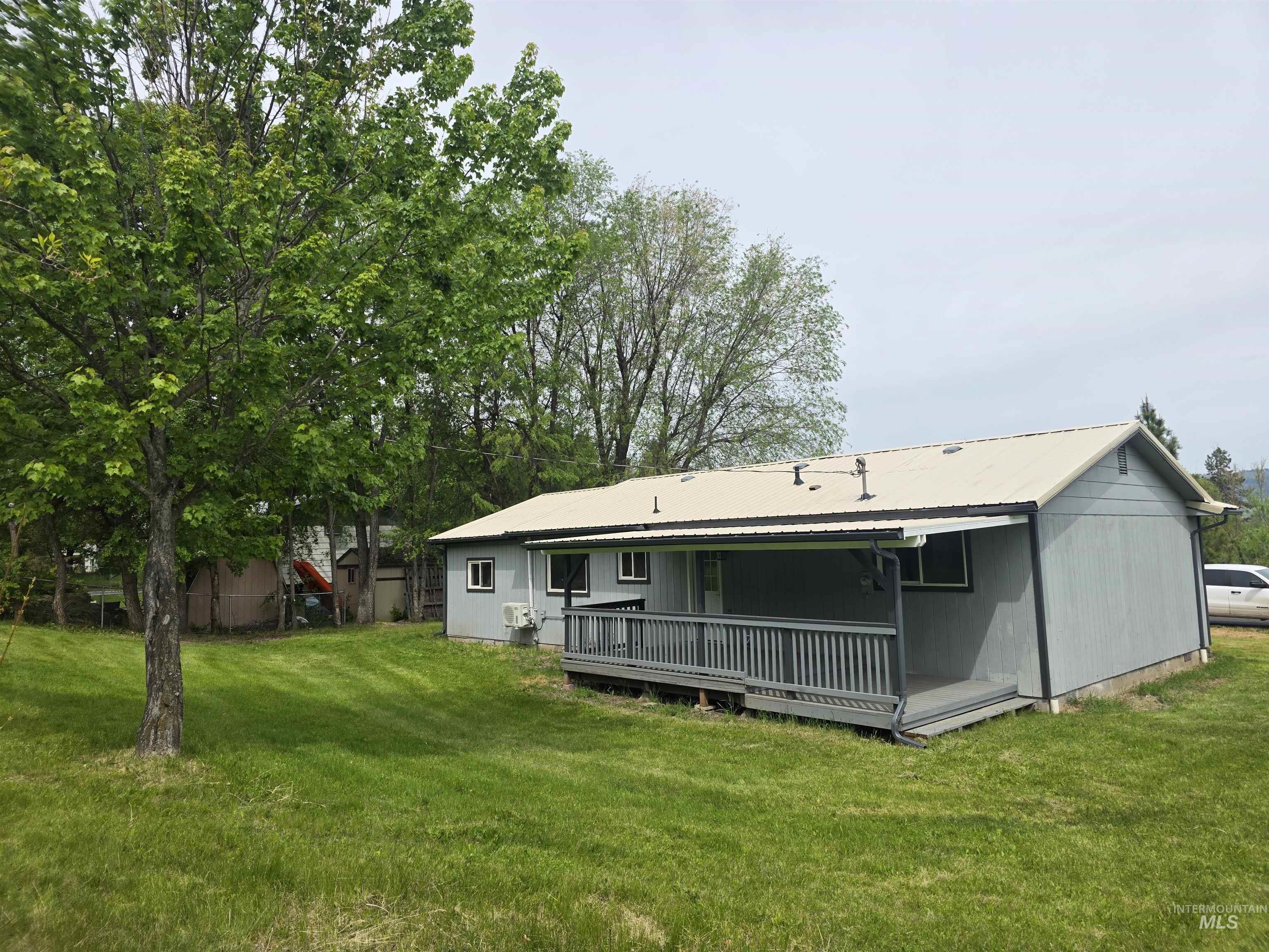 310 Fir Road Kamiah, ID 83536 - Photo 2 of 32 Single-story residence featuring a metal roof, light gray siding, and a covered porch with railings