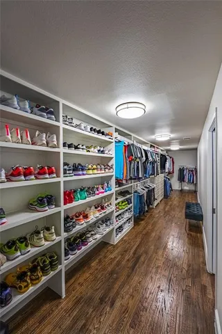 a room with lots of books and a large window