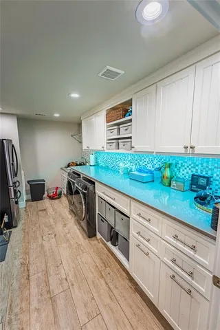 a kitchen with stainless steel appliances kitchen island granite countertop a sink and cabinets